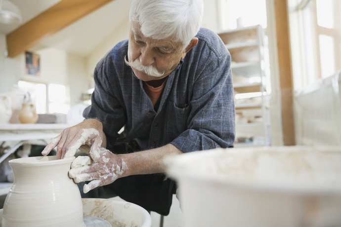 Older man creating ceramic art